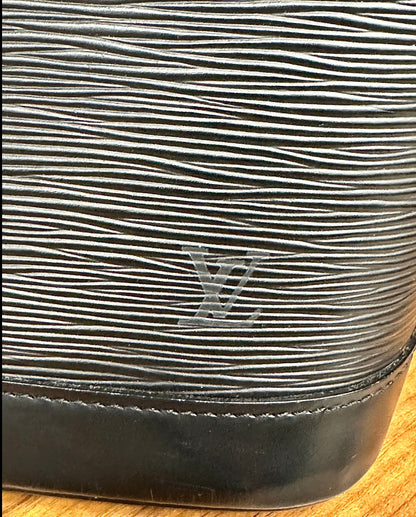 LV logo on corner of bag with scuff marks 