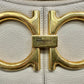 Close up photo of Ferragamo logo on front in gold with scratches on hardware