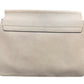 A light beige leather shoulder bag with a flap closure and gold-tone hardware, shown against a plain white background.