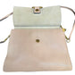 Open leather shoulder bag with a large beige leather front flap and a beige suede flap, featuring gold-tone hardware and a matching shoulder strap.