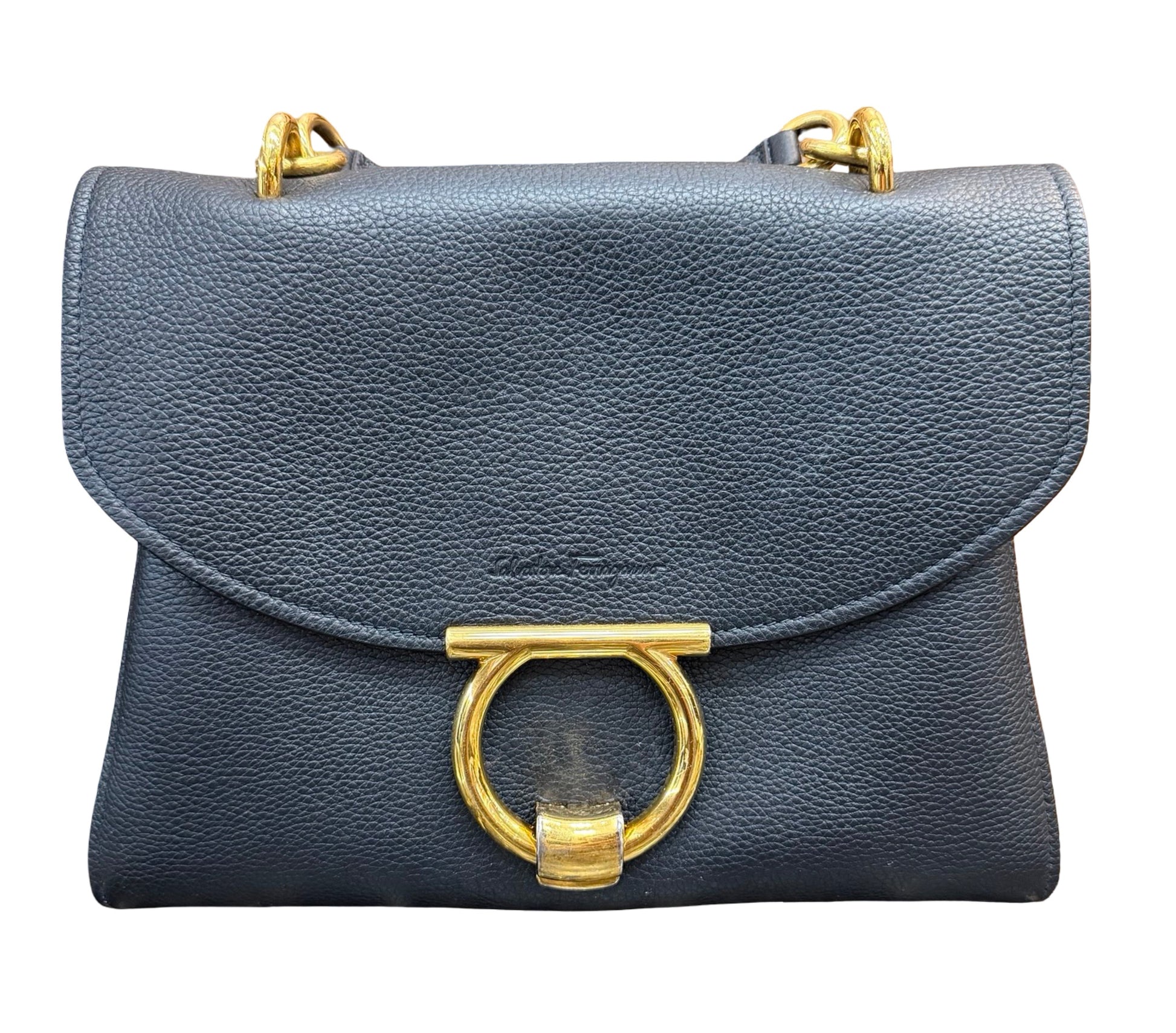 A black pebbled leather shoulder bag with a large gold-tone ring clasp and gold-tone chain strap hardware, shown against a plain white background.
