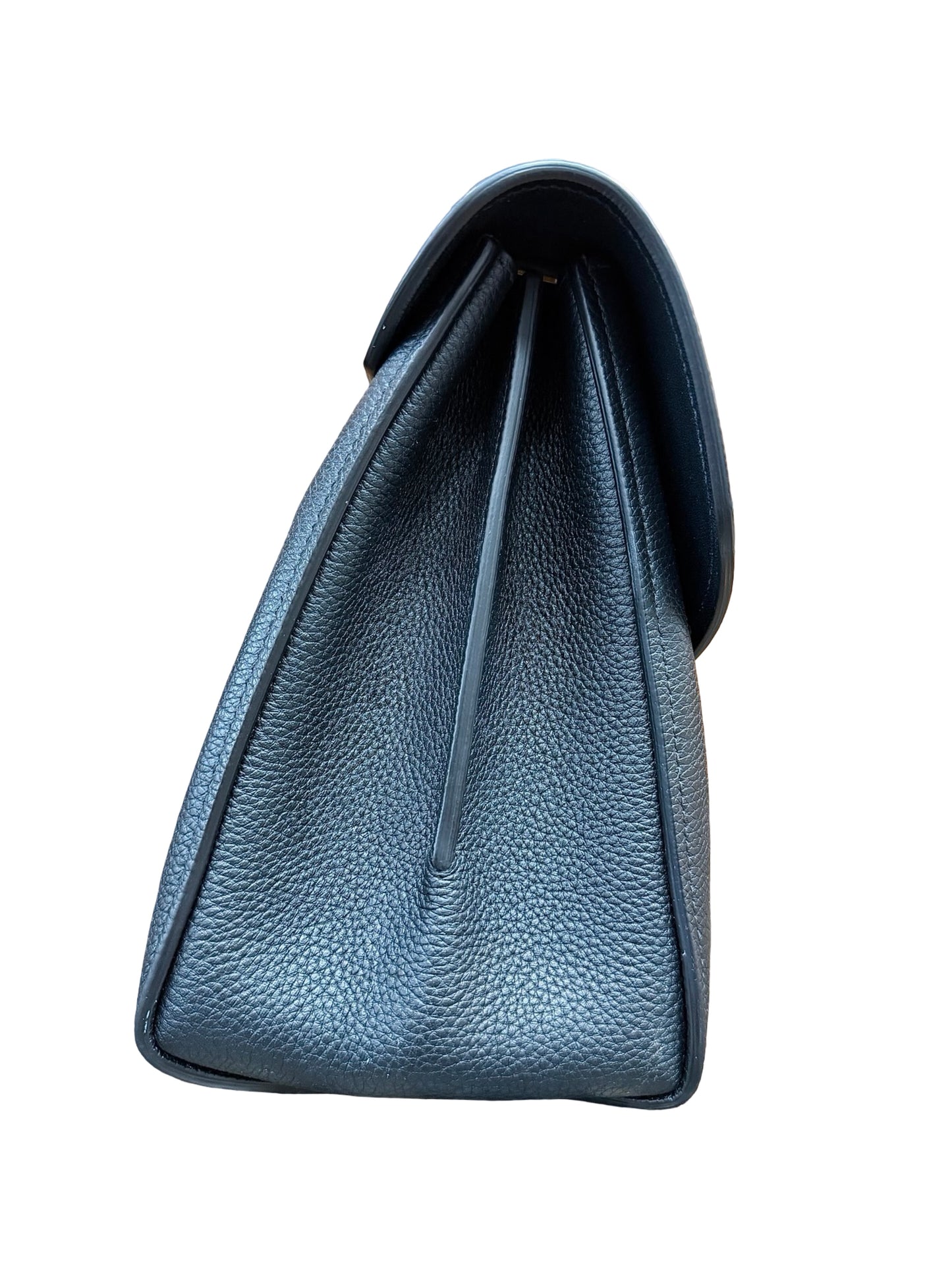 A close-up side view of the black bag showing the pebbled grain and a central seam, set against a plain white background.