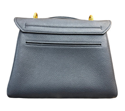 Back of a black pebbled leather handbag with gold-tone hardware, against a plain white background.