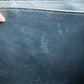 Close-up of the black leather interior with scuff marks on the interior.