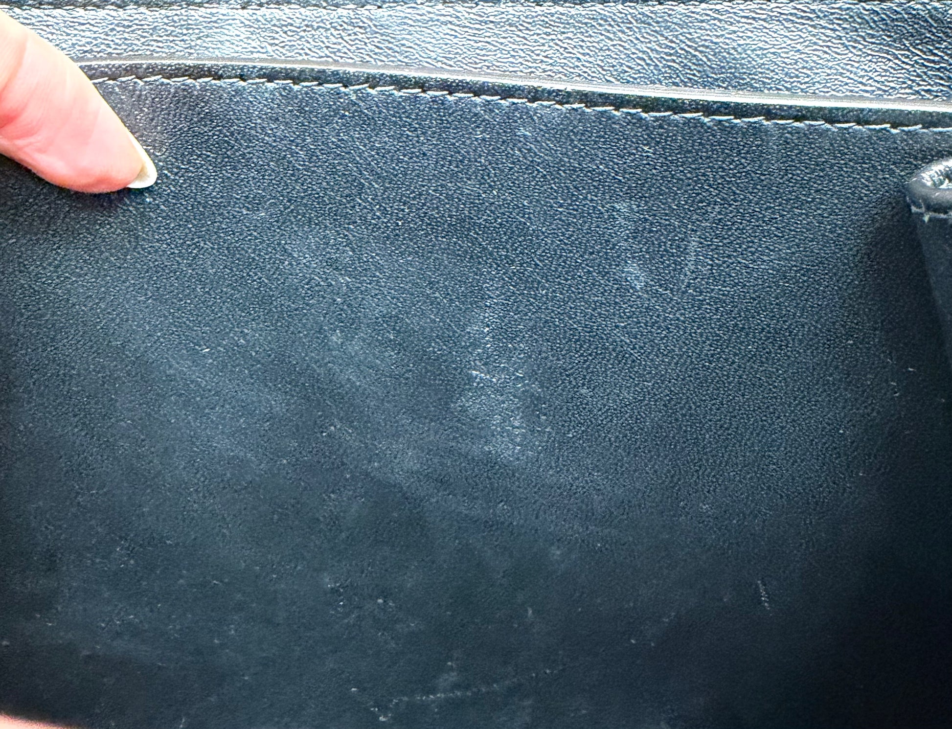 Close-up of the black leather interior with scuff marks on the interior.