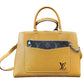 A Louis Vuitton brown epi leather handbag with a brown monogram chain wallet in the front pocket and silver-tone hardware, shown on a plain white background.