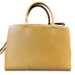 A structured brown leather handbag with a textured diagonal grain pattern, featuring two top handles and a shoulder strap, shown against a plain white background.