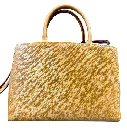 A structured brown leather handbag with a textured diagonal grain pattern, featuring two top handles and a shoulder strap, shown against a plain white background.