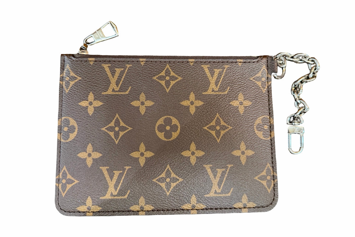 A Louis Vuitton monogram small pouch in brown coated canvas with silver hardware, featuring a silver-tone chain link and clasp on the right side.