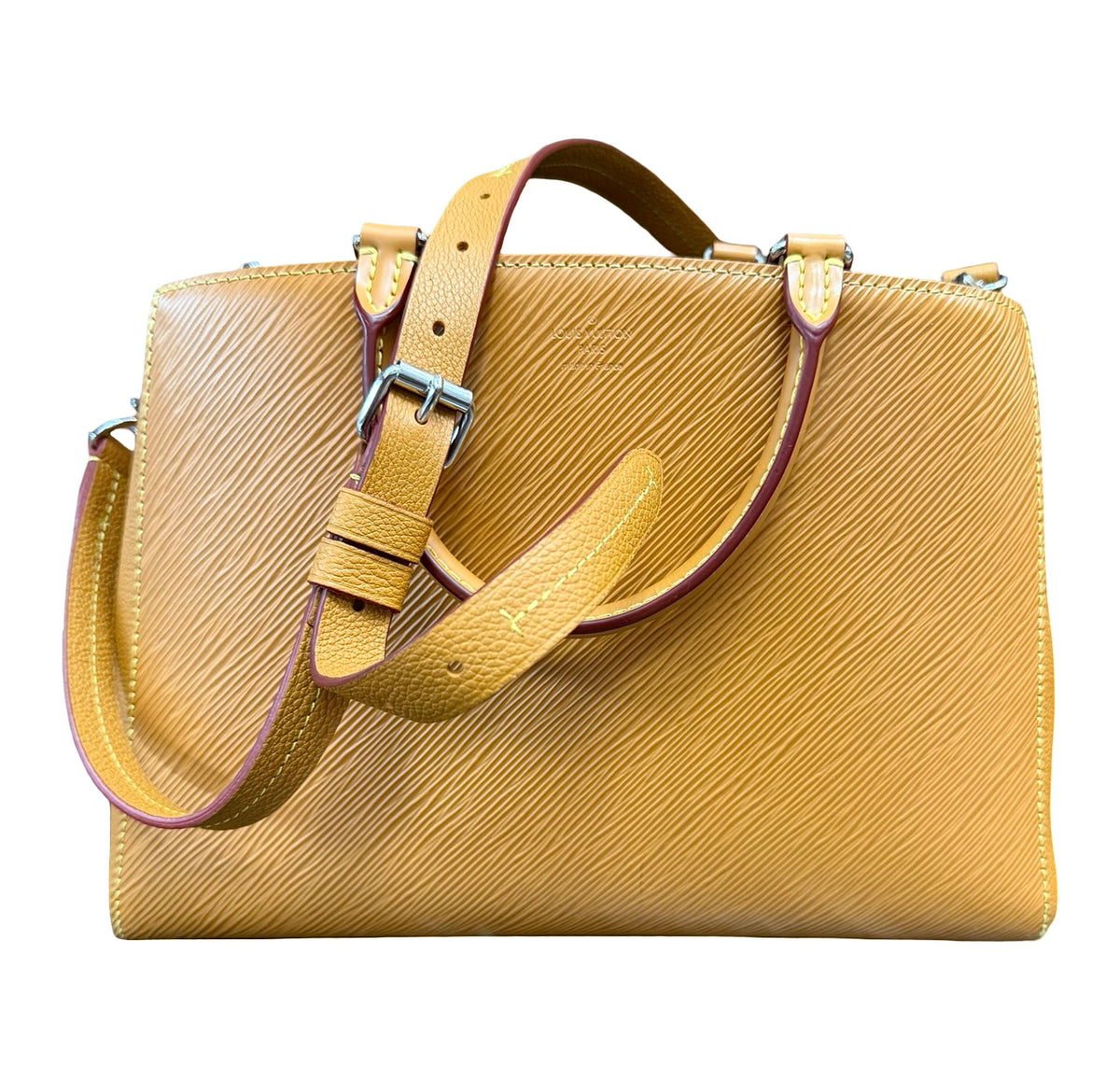 A structured brown epi leather handbag with a top handle, shoulder strap, and silver-tone hardware, shown against a plain white background. The strap is misshaped at the end.