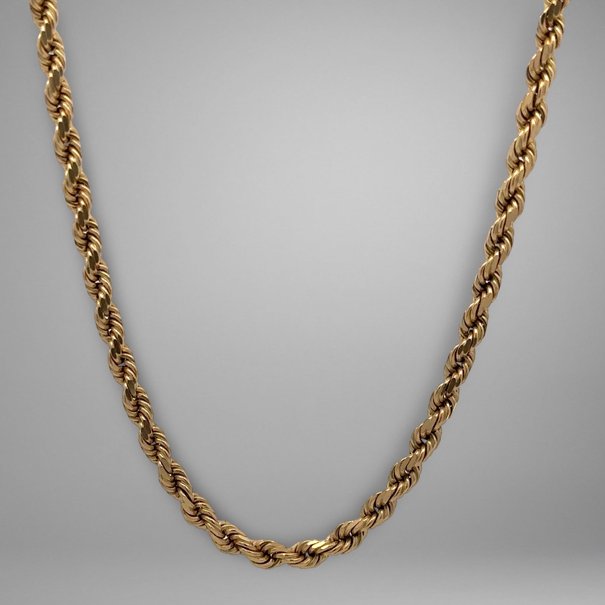 Gold chain on a gray background
