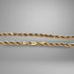 Gold rope chain on a gray background
