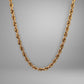 Gold chain necklace on a gray background