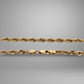 Gold rope chain on a gray background