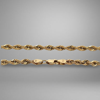 Gold rope chain on a gray background