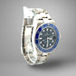 Silver watch with blue bezel and black face on a gray background