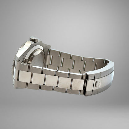 Silver watch with a detailed band on a gray background