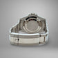 Silver watch case on a gray background