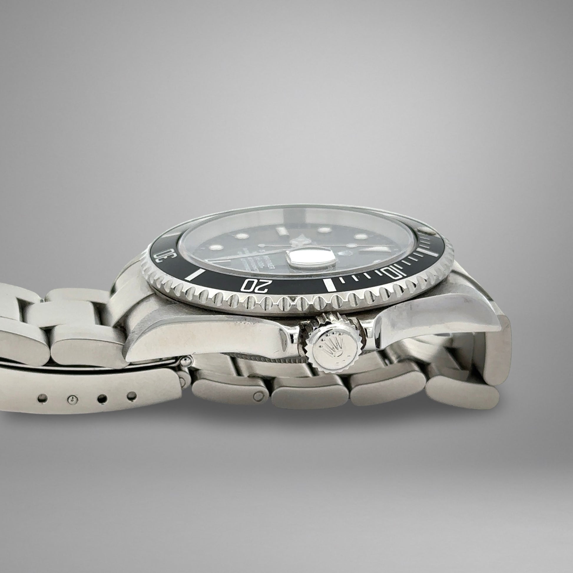 Silver watch with a black dial on a gray background