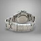 Silver watch with metal band on a gray background