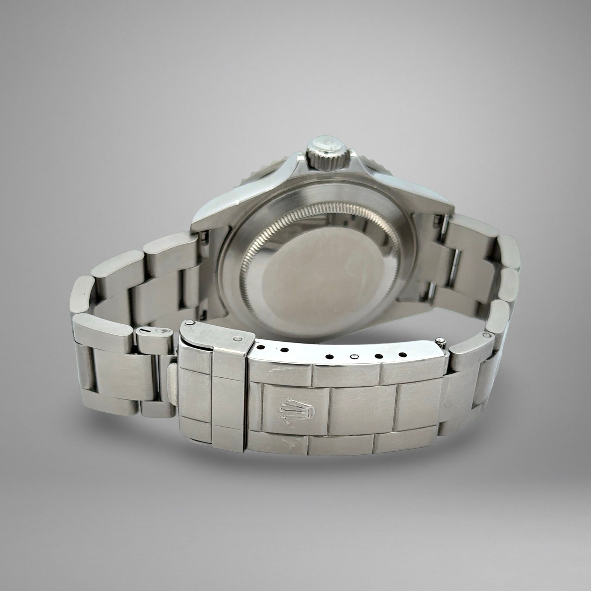 Silver watch with metal band on a gray background