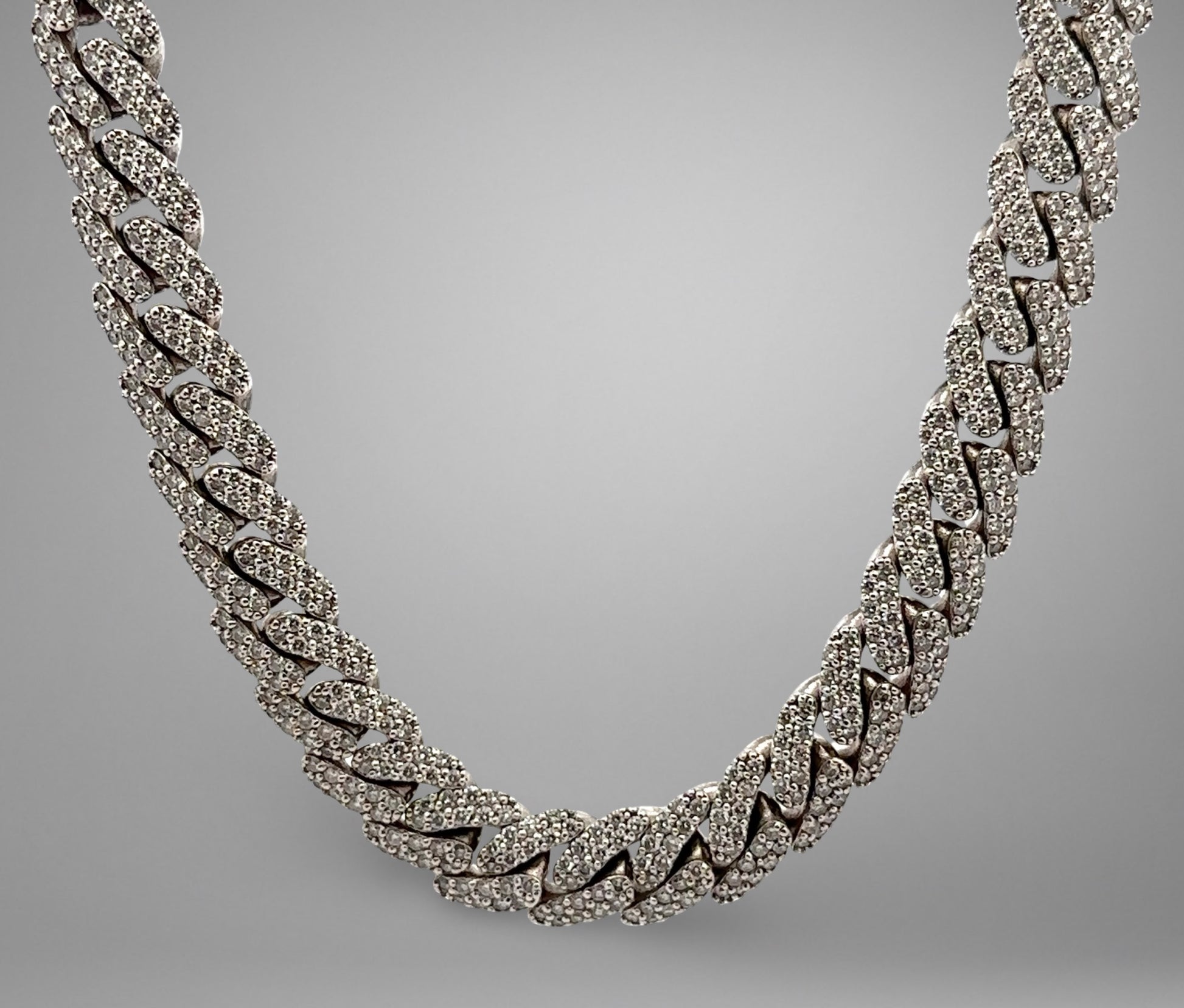 Silver chain necklace on a gray background