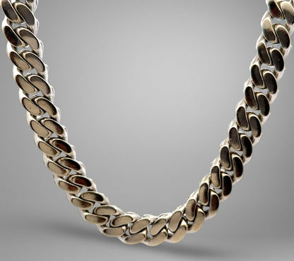 Silver chain necklace on a gray background