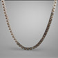 Silver necklace with brown beads on a gray background
