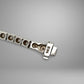 Close-up of a silver bracelet on a gray background