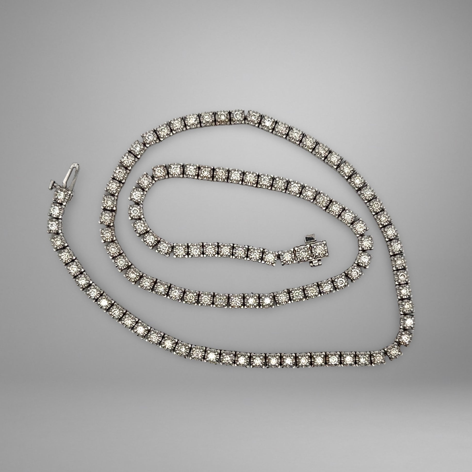Diamond tennis necklace on a gray background