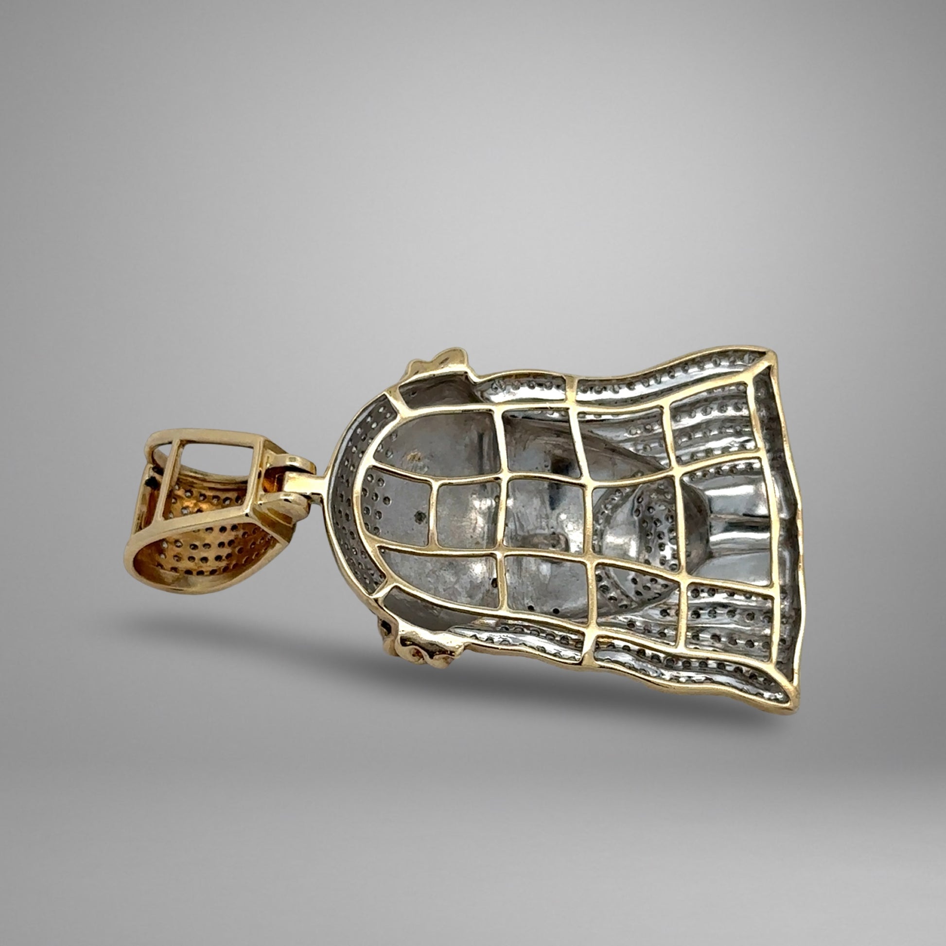Gold pendant on a gray background