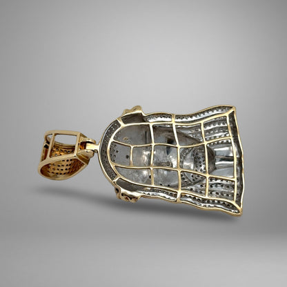 Gold pendant on a gray background