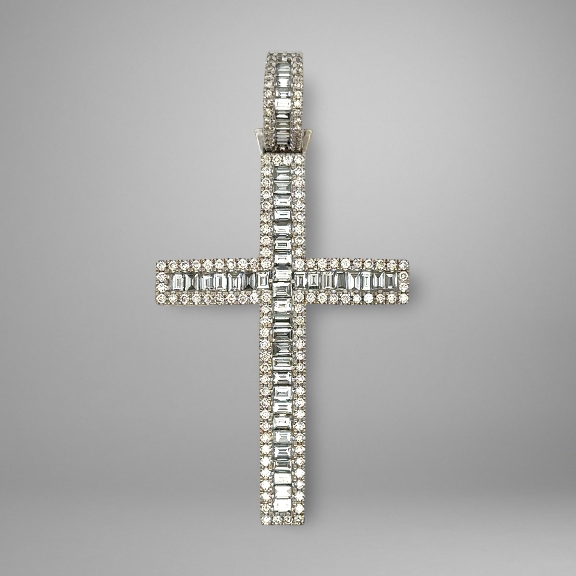 Diamond cross pendant on a gray background