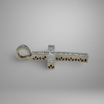 Silver cross pendant with diamonds on a gray background