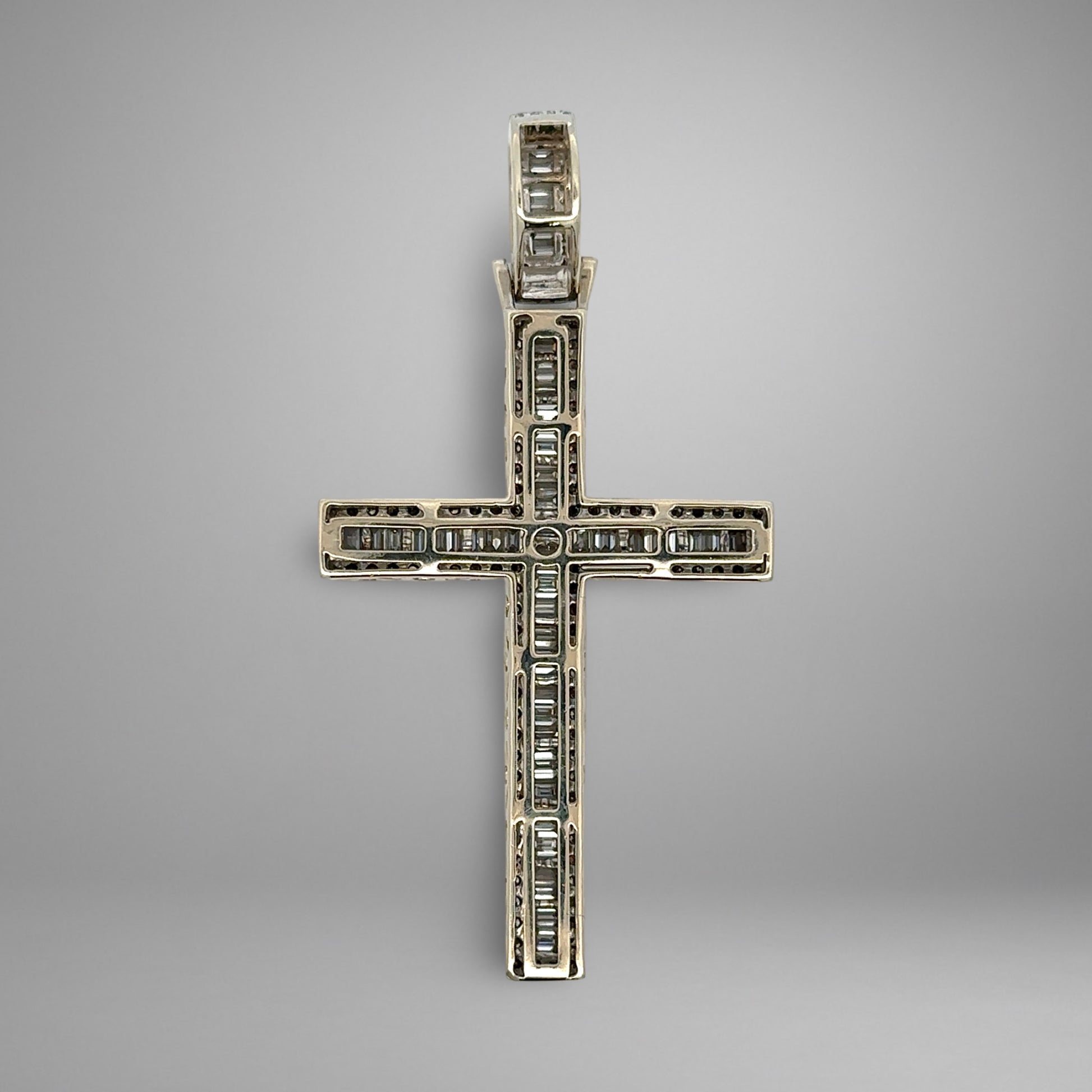 Back of diamond cross pendant on a gray background