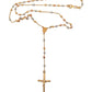 A gold-tone rosary necklace with alternating gold, white gold, and rose gold beads, featuring a gold medallion and a crucifix pendant, displayed on a clean white background.