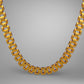 Gold necklace on a gray background
