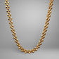 Gold chain necklace on a gray background