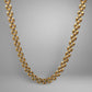 Gold chain necklace on a gray background