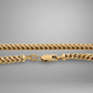 Gold chain necklace on a gray background