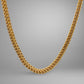 Gold chain necklace on a gray background