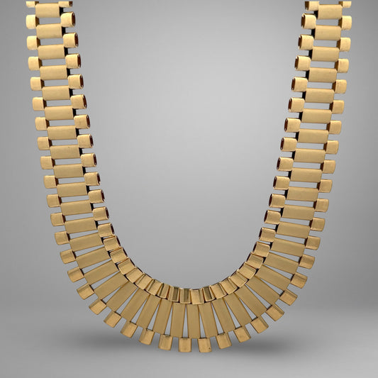 Gold necklace on a gray background