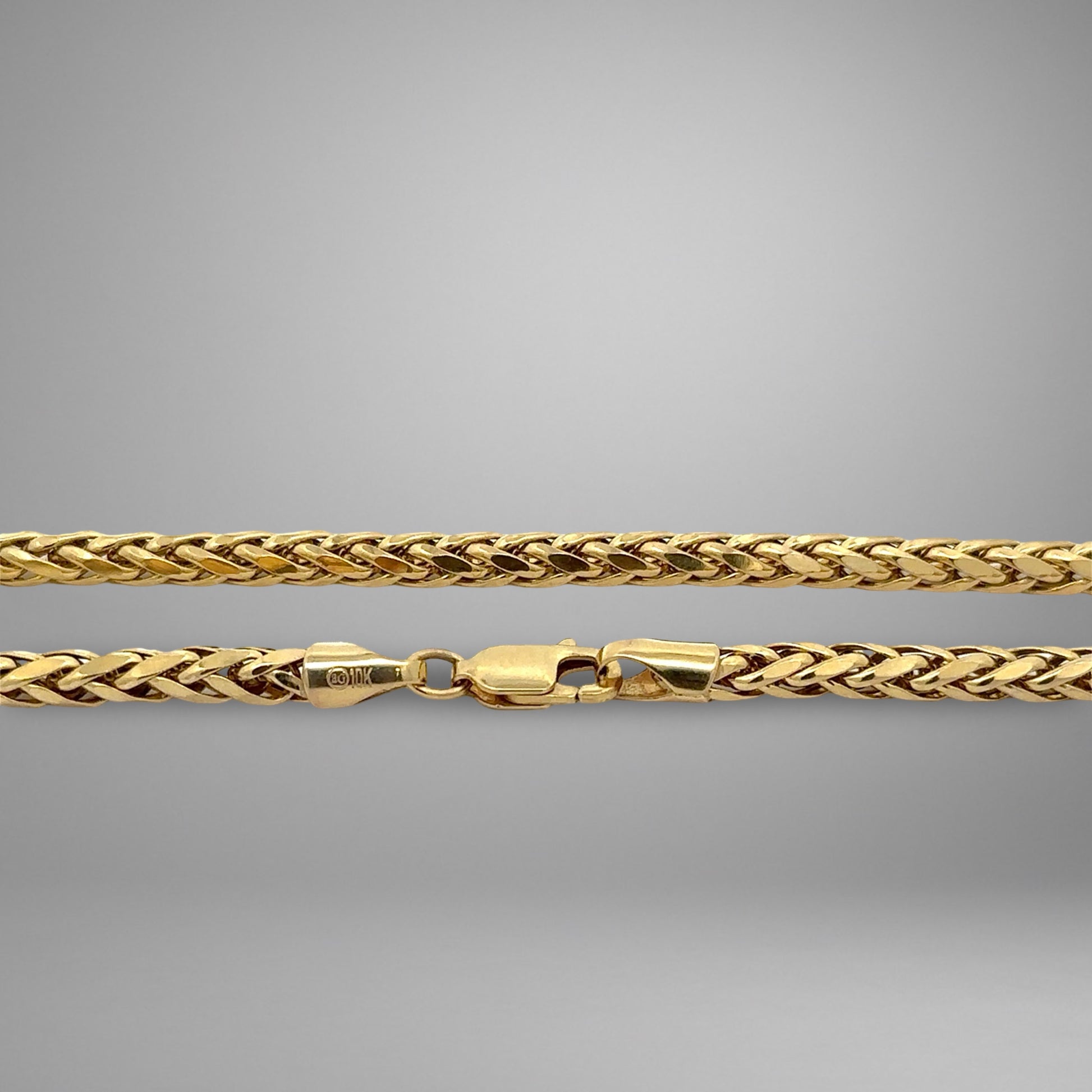 Gold chain on a gray background