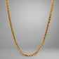 Gold chain necklace on a gray background