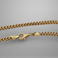 Gold chain necklace on a gray background