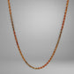 Yellow gold, rose gold, & white gold rope chain on grey background