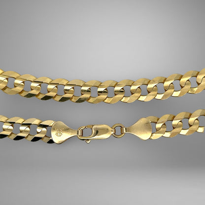 Gold chain necklace on a gray background