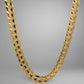 Gold chain necklace on a gray background