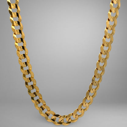 Gold chain necklace on a gray background