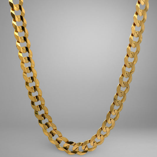 Gold chain necklace on a gray background